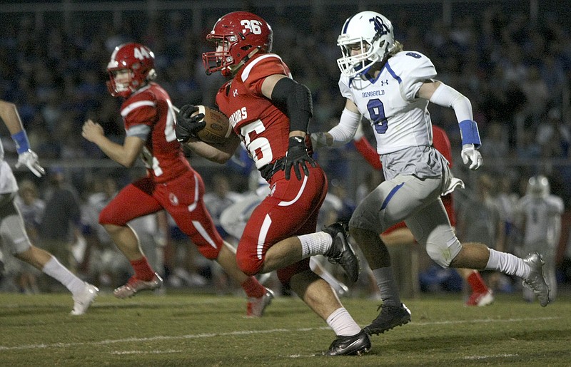 Ringgold's Blake Goldsmith (8) chases Lakeview-Fort Oglethorpe's Nathan Williams (36) at Lakeview-Fort Oglethorpe High School's Tommy Cash Stadium on Friday, Sept. 29, in Fort Oglethorpe, Ga.