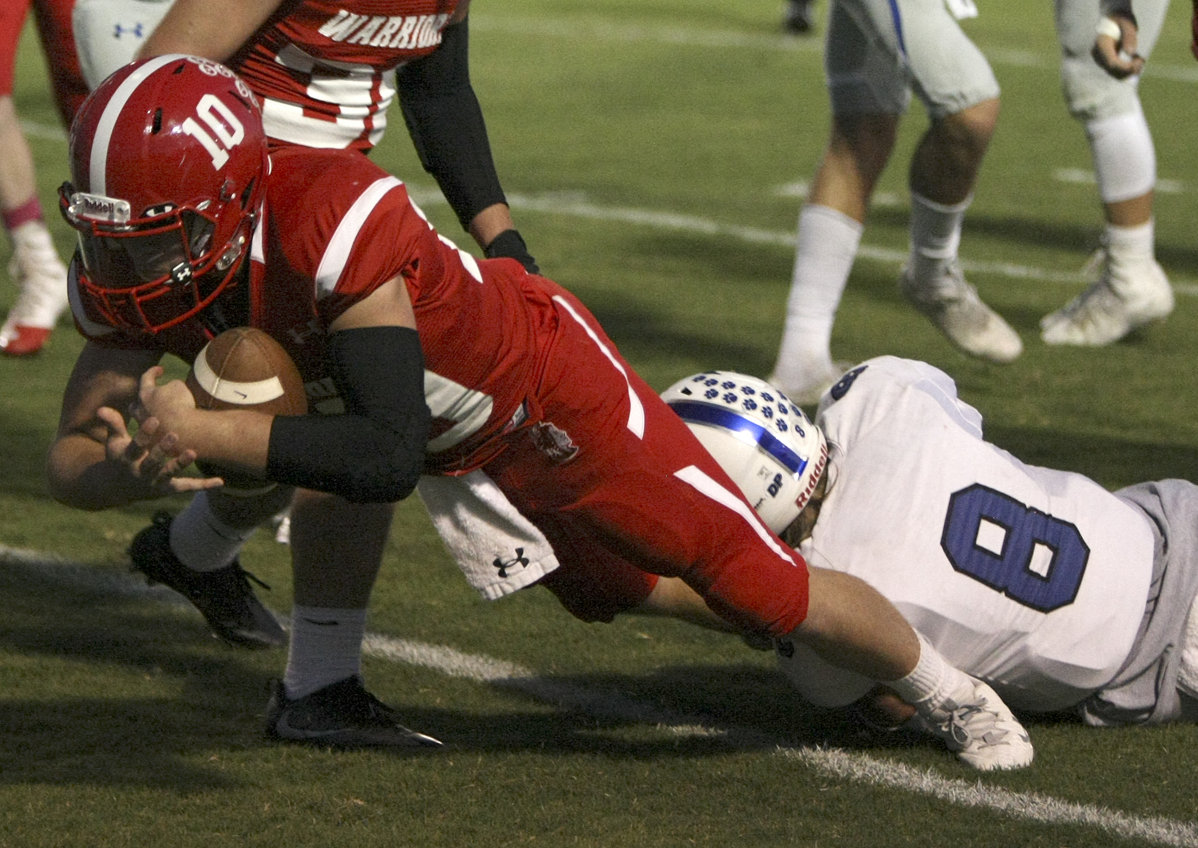 Lakeview-Fort Oglethorpe's Zach Vaughn dives for extra yardage as he is tackled by Ringgold's Blake Goldsmith (8) at Lakeview-Fort Oglethorpe High School's Tommy Cash Stadium on Friday, Sept. 29, in Fort Oglethorpe, Ga.