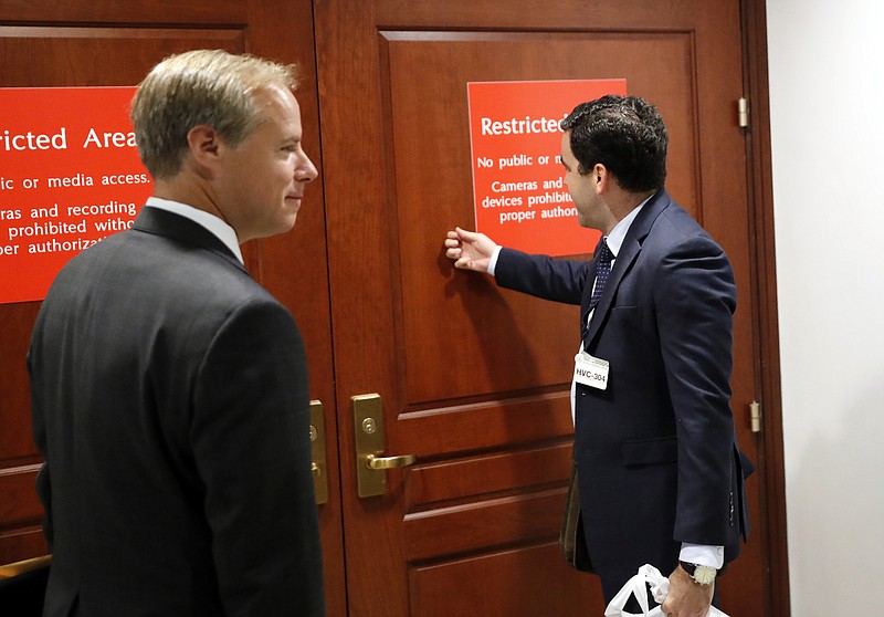 
              Twitter's Carlos Monje, the director of public policy and philanthropy, right, knocks on the door with Colin Crowell, head of global public policy, to enter the closed door meeting with the House Intelligence Committee on Capitol Hill, Thursday, Sept. 28, 2017 in Washington. Officials from Twitter are on Capitol Hill as part of the House and Senate investigations into Russian interference in the 2016 elections. (AP Photo/Alex Brandon)
            