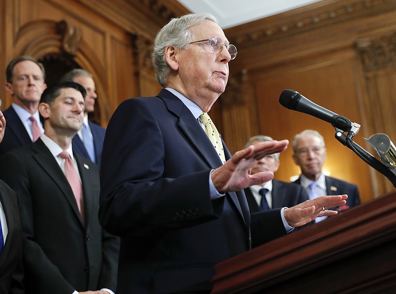 
              Senate Majority Leader Mitch McConnell, R-Ky., center, with Speaker of the House Paul Ryan, R-Wis., left, and other GOP members as they talk about the Republicans' proposed rewrite of the tax code for individuals and corporations, at the Capitol in Washington, Wednesday, Sept. 27, 2017. President Donald Trump and congressional Republicans are writing a far-reaching, $5-trillion plan they say would simplify the tax system and nearly double the standard deduction used by most Americans. (AP Photo/Pablo Martinez Monsivais)
            