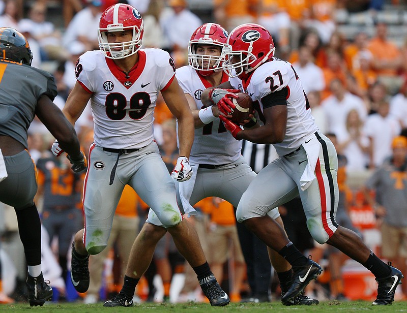 Georgia quarterback Jake Fromm hands the ball off to Nick Chubb (27) during the Bulldogs' 41-0 win Saturday at Tennessee. Chubb finally had a fun day against the Vols and ran for 109 yards.