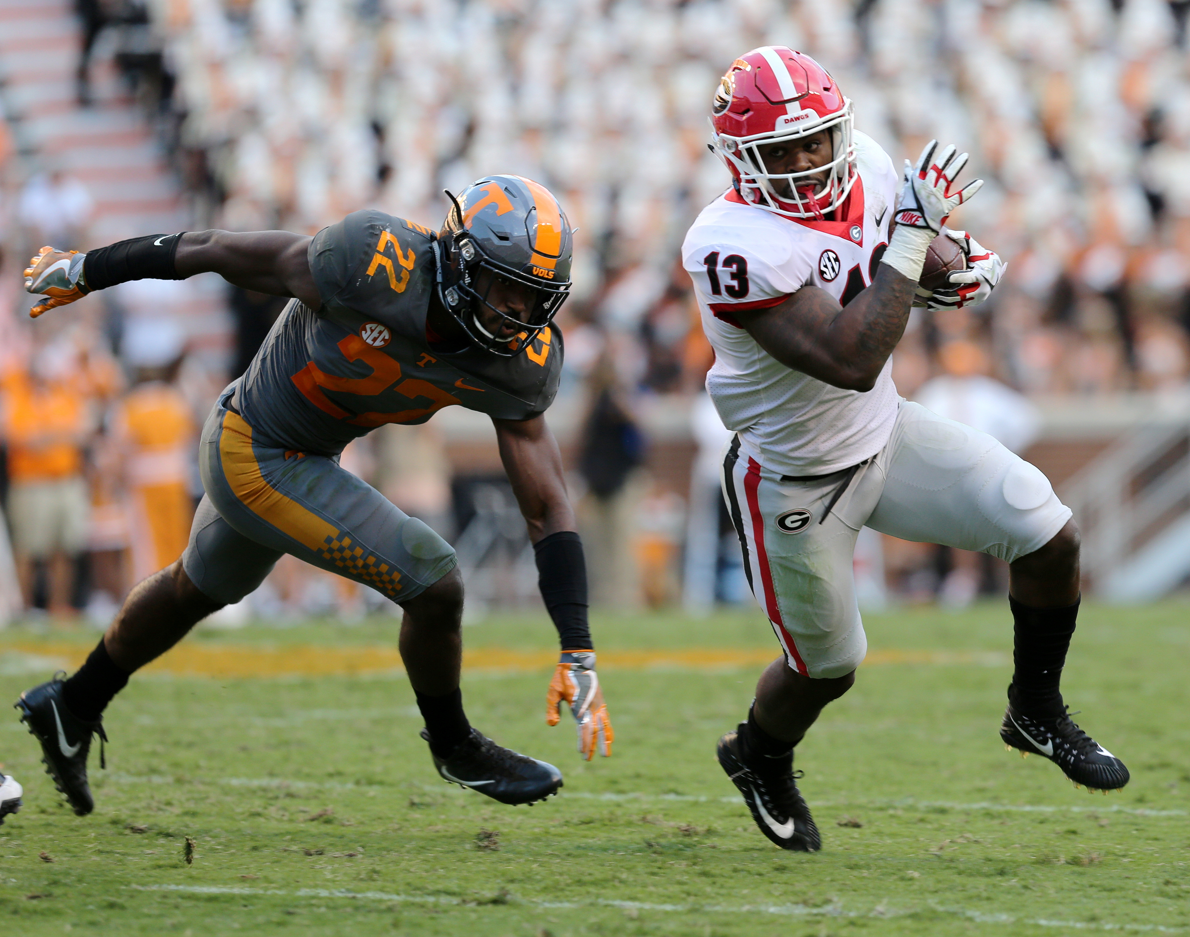 University of Tennessee's Micah Abernathy (22) misses a tackle on University of Georgia's Elijah Holyfield (13) during the University of Tennessee vs. University of Georgia football game at Neyland Stadium in Knoxville, Tenn., Saturday, Sept. 30, 2017.