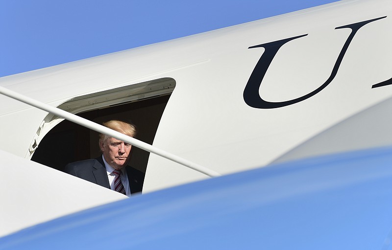 
              President Donald Trump steps through the door of Air Force One at Morristown Municipal Airport in Morristown, N.J., Friday, Sept. 29, 2017. Trump is spending the weekend in Bedminster, N.J., at his golf club. (AP Photo/Susan Walsh)
            