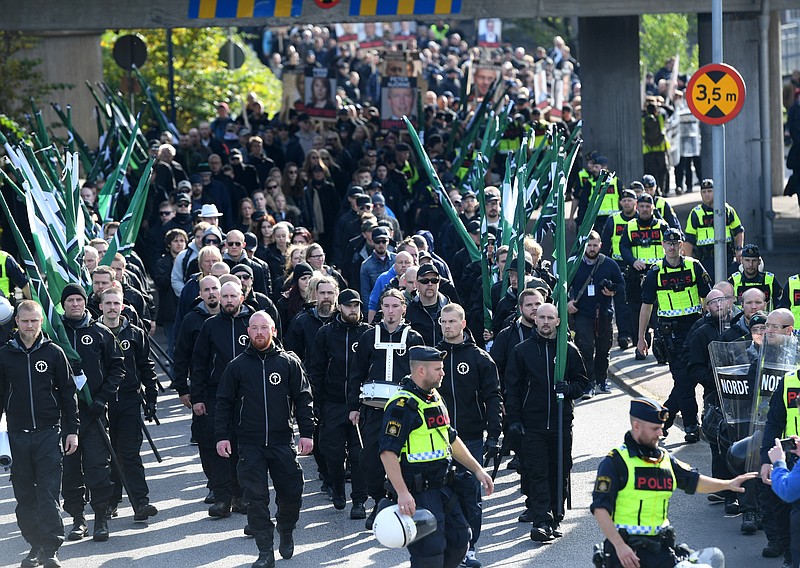 
              Members of the Nordic Resistance Movement march in central Goteborg, Sweden, Saturday Sept. 30, 2017. The authorities say the Nordic Resistance Movement expects some 1,000 people to march Saturday while as many as 10,000 people could counter-demonstrate. (Fredrik Sandberg/TT via AP)
            