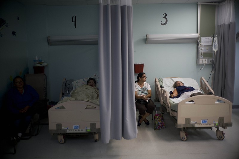 
              In this Thursday, Sept. 28, 2017 photo, patients lie in their beds at hospital in Catano, Puerto Rico. In Hurricane Maria’s wake, hospitals and their employees are wrestling with the same shortages of basic necessities as everyone else. There are people who are unable to keep insulin or other medicines refrigerated. The elderly are particularly vulnerable to the tropical heat as widespread power outages mean no air-conditioning. (AP Photo/Ramon Espinosa)
            