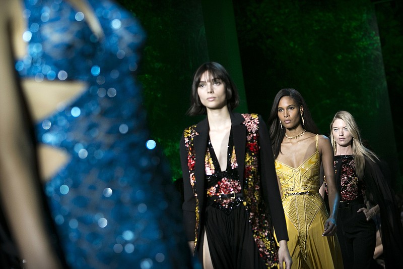 
              Models, including Cindy Bruna, second from right, and Martha Hunt, right, wear creations for Elie Saab's Spring-Summer 2018 ready-to-wear fashion collection presented Saturday, Sept. 30, 2017 in Paris. (AP Photo/Kamil Zihnioglu)
            