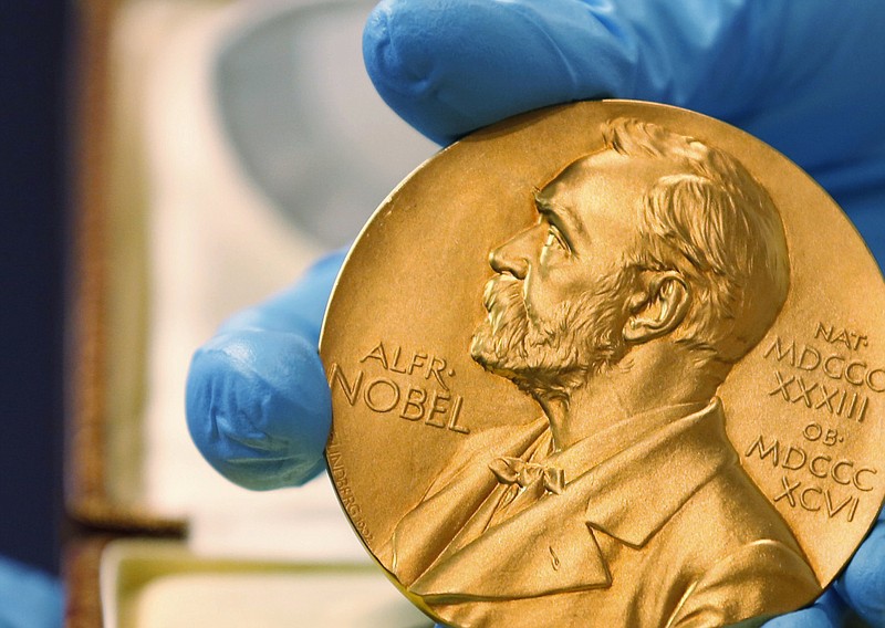 
              FILE- In this file photo dated Friday, April 17, 2015, a national library employee shows the gold Nobel Prize medal awarded to the late novelist Gabriel Garcia Marquez, in Bogota, Colombia. The Nobel prize has greater personal impact than merely receiving the monetary award, as it marks the recipient in terms of esteem and global recognition. (AP Photo/Fernando Vergara, FILE)
            