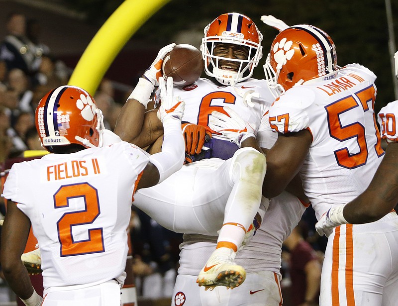 
              Clemson linebacker Dorian O'Daniel (6) celebrates with his teammates after a pick six during the second half of an NCAA college football game in Blacksburg, Va., Saturday, Sept. 30, 2017. Clemson won the game 31-17. (AP Photo/Steve Helber)
            