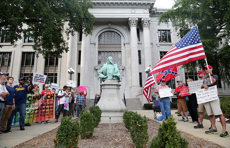 Protestors of the A.P. Stewart statue as well as counter protestors stand on either side of the statue in front of the Hamilton County Courthouse Sunday, Oct. 1, 2017, in downtown Chattanooga, Tenn. The NAACP and Mercy Junction staged a march and prayer vigil to call for the removal of the A.P. Stewart statue outside the Hamilton County Courthouse. 