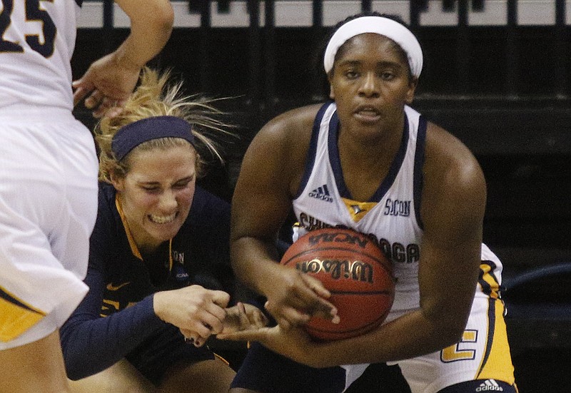 UTC guard Aryanna Gilbert, right, steals the ball from ETSU guard Malloree Schurr during a home game last season. Gilbert is the only player who was with the Mocs before Jim Foster took over as coach four years ago.