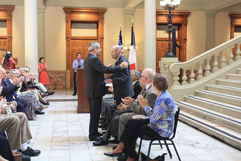 French Consul General Louis de Corail pins Captain Donald Seesenguth with the French Legion of Honor at the Georgia State Capitol in Atlanta