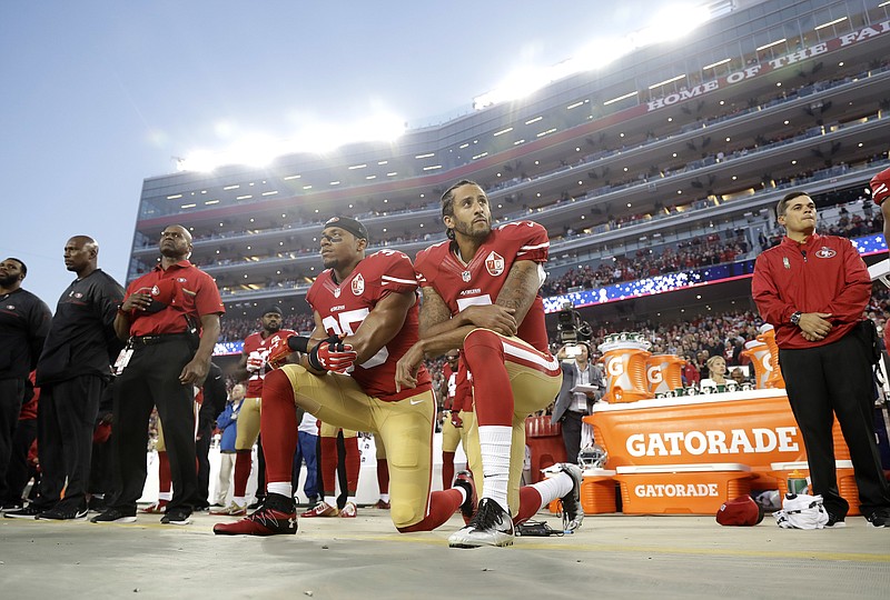 In this Monday, Sept. 12, 2016, file photo, San Francisco 49ers safety Eric Reid (35) and quarterback Colin Kaepernick (7) kneel during the national anthem before an NFL football game against the Los Angeles Rams in Santa Clara, Calif. Reid has resumed his kneeling protest for human rights during the national anthem, after joining then-teammate Kaepernick's polarizing demonstration last season. (AP Photo/Marcio Jose Sanchez, File)