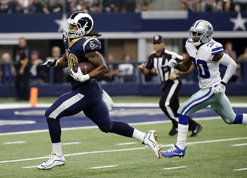 
              Los Angeles Rams running back Todd Gurley (30) sprints to the end zone past Dallas Cowboys cornerback Anthony Brown, right, for a touchdown in the second half of an NFL football game, Sunday, Oct. 1, 2017, in Arlington, Texas. (AP Photo/Michael Ainsworth)
            