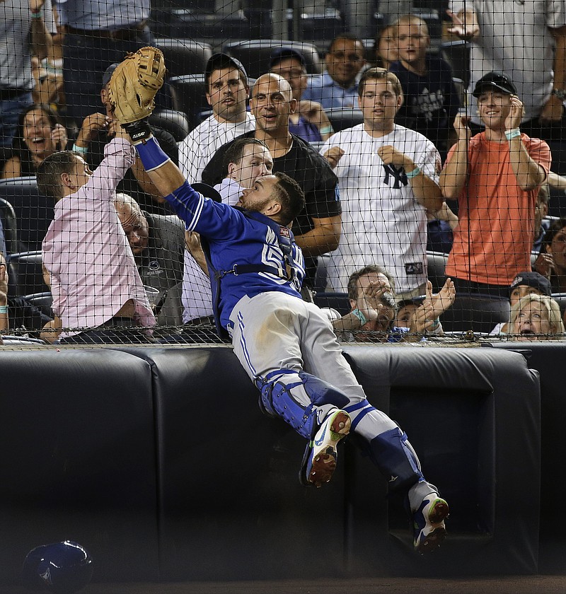 
              FILE - In this Friday, Aug. 7, 2015 file photo, Toronto Blue Jays catcher Russell Martin (55) catches a pop foul by New York Yankees' Stephen Drew as he leaps against the backstop netting during the seventh inning of a baseball game at Yankee Stadium in New York. The New York Yankees plan to expand protective netting at their home ballpark and spring training complex next year. The team announced the decision during its final regular-season game Sunday, Oct. 1, 2017 against Toronto. (AP Photo/Julie Jacobson)
            