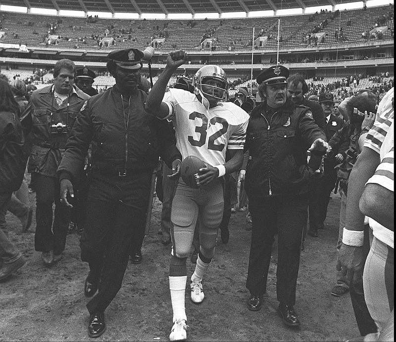 
              FILE - In this Dec. 16, 1979 file photo, San Francisco 49ers running back O.J. Simpson is escorted from the field by police after the final NFL football game of his career against in the Atlanta Falcons at Atlanta Fulton County Stadium in Atlanta, Ga. Simpson retired from football after the 1979 season, later being inducted into the Pro Football Hall of Fame and beginning careers in acting and football broadcasting. A Nevada prison official said early Sunday, Oct. 1, 2017, O.J. Simpson, the former football legend and Hollywood star, has been released from a Nevada prison in Lovelock after serving nine years for armed robbery.  (AP Photo, File)
            