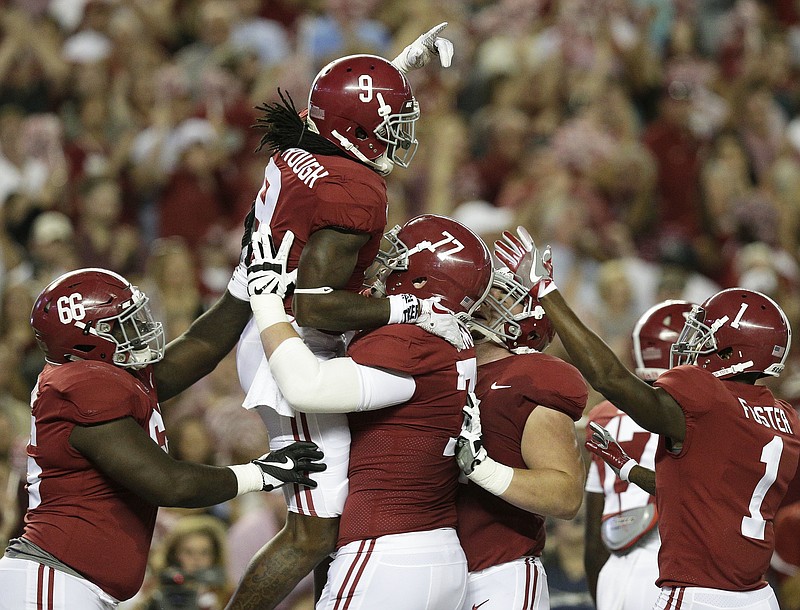 Alabama running back Bo Scarbrough celebrates with teammates after scoring a touchdown during the first half of an NCAA college football game against Mississippi, Saturday, Sept. 30, 2017, in Tuscaloosa, Ala. (AP Photo/Brynn Anderson)