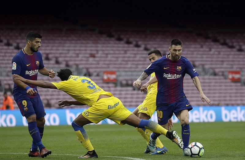 
              Barcelona's Lionel Messi, right, is challenged by Las Palmas' Mauricio Lemos, center, during the Spanish La Liga soccer match between Barcelona and Las Palmas at the Camp Nou stadium in Barcelona, Spain, Sunday, Oct. 1, 2017. Barcelona's Spanish league game against Las Palmas is played without fans amid the controversial referendum on Catalonia's independence. (AP Photo/Manu Fernandez)
            