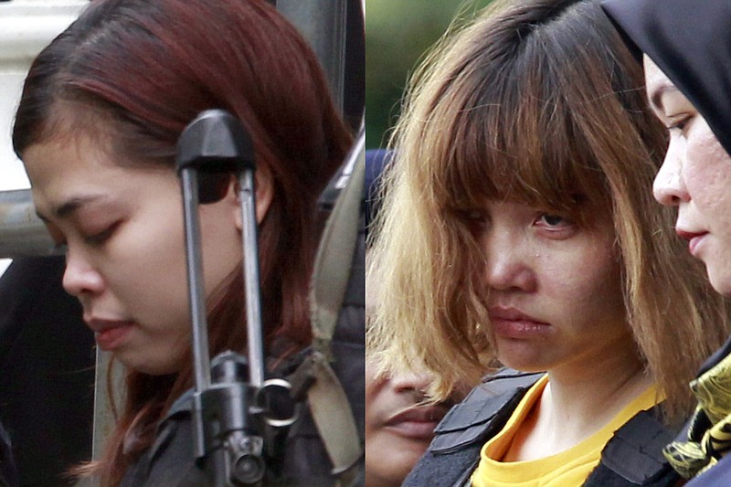 
              FILE - In this combination of March 1, 2017, file photos, Indonesian suspect Siti Aisyah, left, and Vietnamese suspect Doan Thi Huong, both suspects in the killing of Kim Jong Nam, North Korean leader Kim Jong Un's estranged half brother, are escorted out of court by police officers in Sepang, Malaysia. The trial of two women accused of poisoning the estranged half brother of North Korea's ruler is scheduled to begin Monday, Oct. 2, 2017,  in Malaysia's High Court, nearly eight months after the brazen airport assassination.(AP Photo/Daniel Chan, File)
            