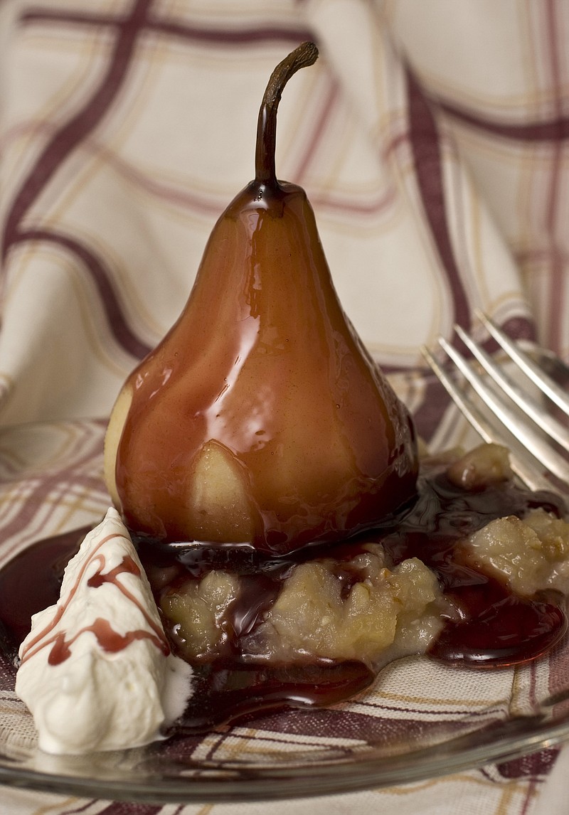 In this AP file photo, a Roasted Red Pear is shown. Pears, wine and sugar have a happy marriage inside a Dutch oven, creating a tender, sweet dessert. (AP Photo/Larry Crowe)