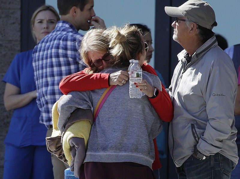 
              Two women embrace outside of a family assistance center Monday, Oct. 2, 2017, in Las Vegas. The makeshift center was set up to help families and others reconnect after the mass shooting on the Las Vegas Strip. (AP Photo/John Locher)
            