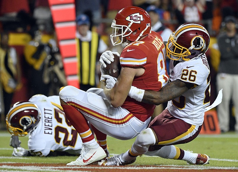 
              Kansas City Chiefs tight end Travis Kelce (87) makes a touchdown catch as Washington Redskins cornerback Bashaud Breeland (26) defends during the first half of an NFL football game in Kansas City, Mo., Monday, Oct. 2, 2017. (AP Photo/Ed Zurga)
            