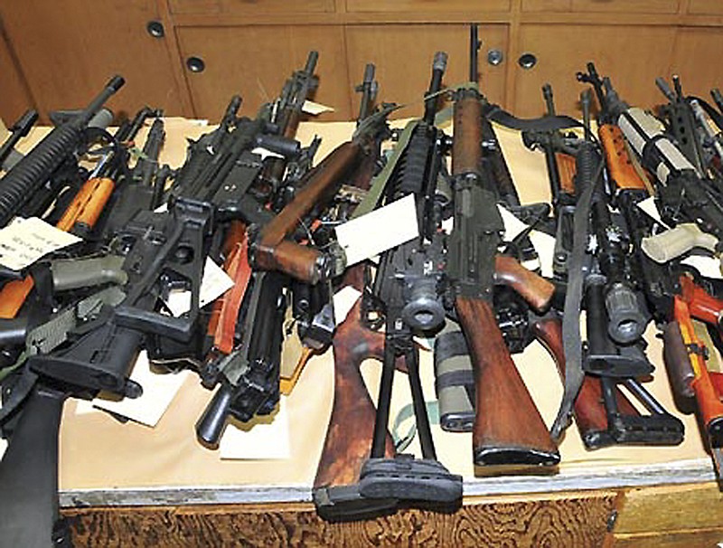 A stash of assault rifles, seized from a California suspect in 2011, is shown.