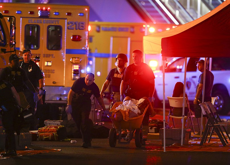 A wounded person is walked in on a wheelbarrow as Las Vegas police respond during an active shooter situation on the Las Vegas Stirp in Las Vegas Sunday. (Chase Stevens/Las Vegas Review-Journal via AP)