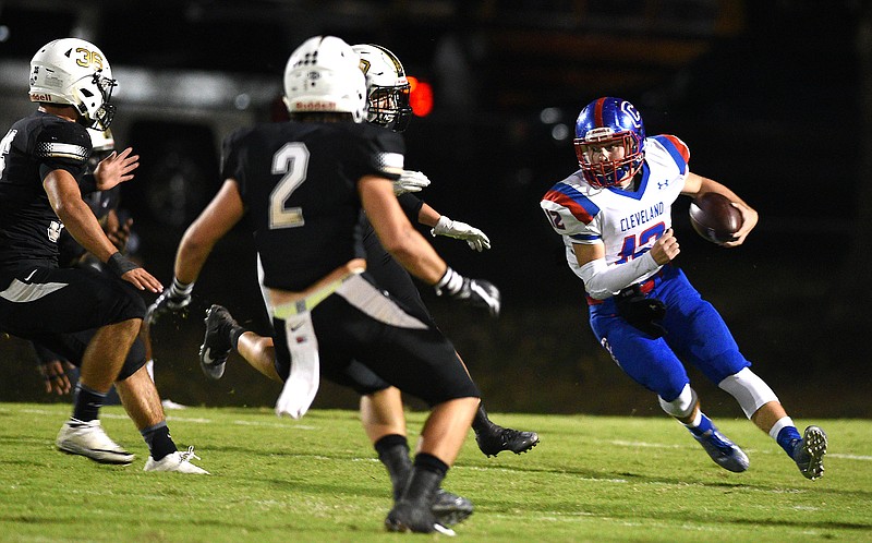 Cleveland quarterback Kellye Cawood (12) tries to get around three Bradley defenders.  The Cleveland Blue Raiders visited the Bradley Central Bears in TSSAA football action of September 15, 2017. 