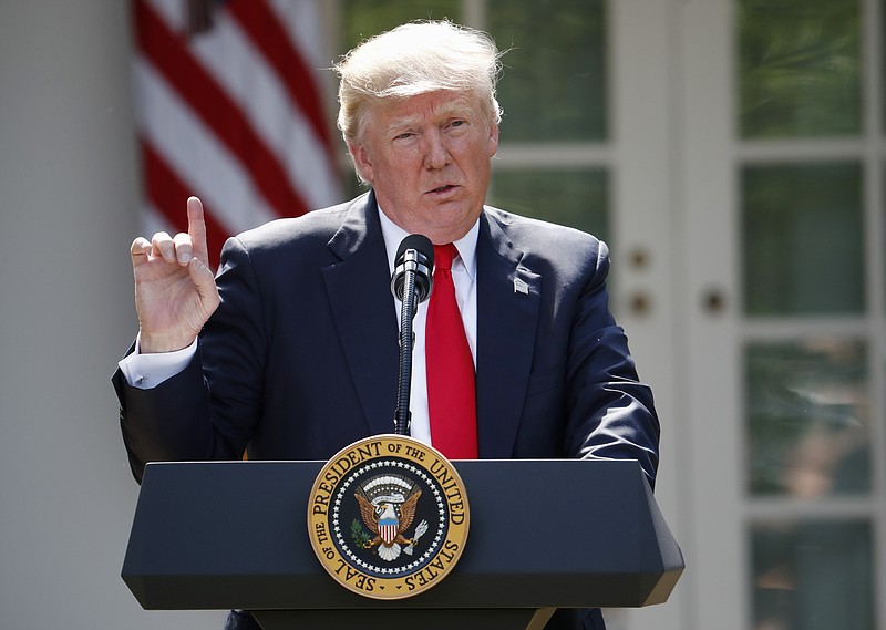 
              FILE - In this Thursday, June 1, 2017 file photo, President Donald Trump speaks about the U.S. role in the Paris climate change accord in the Rose Garden of the White House in Washington. A new Associated Press-NORC poll finds that Americans want local officials to do more to battle global warming now that federal officials aren’t. The poll finds more Americans than not disagree with Trump’s pulling the United States of Paris treaty to fight climate change. So 57 percent of those surveyed said they want local governments to pick up the slack in keeping the world from warming too much. (AP Photo/Pablo Martinez Monsivais, File)
            