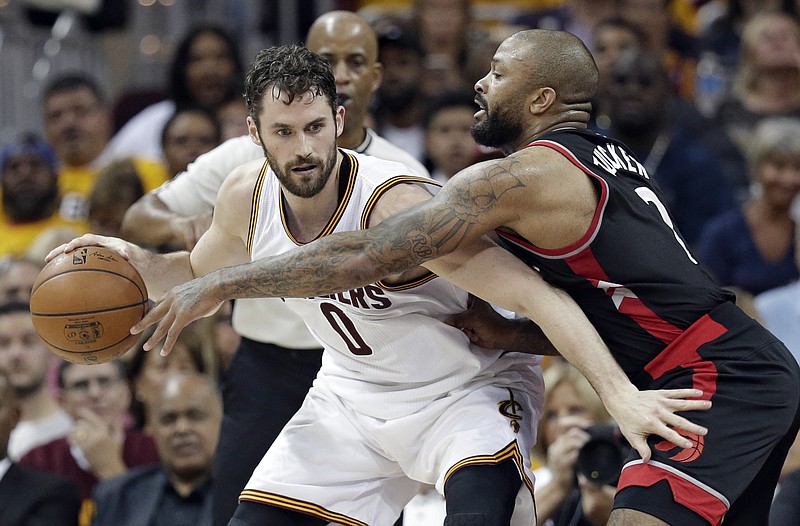 
              FILE - In this May 1, 2017, file photo, Cleveland Cavaliers' Kevin Love, left, tries to keep the ball from Toronto Raptors' P.J. Tucker during the first half in Game 1 of a second-round NBA basketball playoff series in Cleveland. Love, who has been the subject of trade speculation for three years in Cleveland, will be the club’s new starting center, coach Tyronn Lue announced Monday night, Oct. 2, after the team played an intrasquad scrimmage at Quicken Loans Arena. Lue has experimented with Love at center during training camp and likes how it opens the floor for LeBron James and others. (AP Photo/Tony Dejak, File)
            