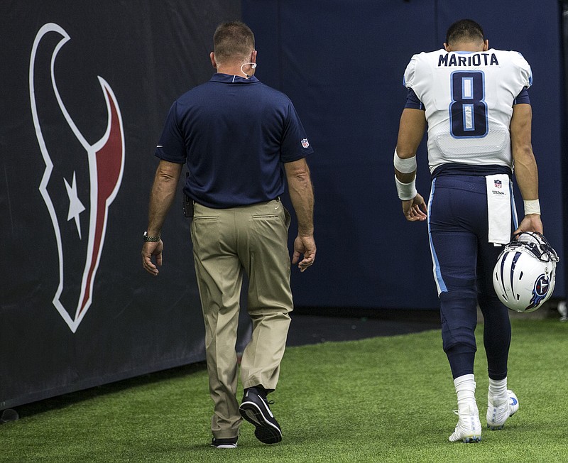 Tennessee Titans quarterback Marcus Mariota (8) walks off the field after suffering a hamstring injury during the third quarter of an NFL football game against the Houston Texans at NRG Stadium on Sunday, Oct. 1, 2017, in Houston. (Brett Coomer/Houston Chronicle via AP)

