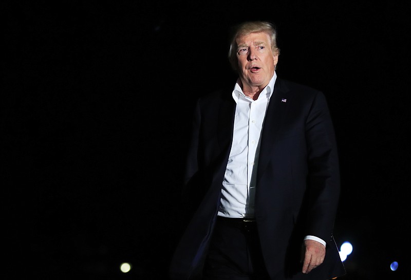 
              President Donald Trump walks on the South Lawn upon his return to the White House in Washington, Sunday, Oct. 1, 2017. (AP Photo/Manuel Balce Ceneta)
            