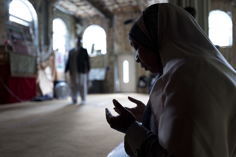 
              In this Sept. 7, 2017 photo, Tahirah Clark, an attorney for the Muslim enclave of Islamberg, prays in the community's mosque in Tompkins, N.Y. The enclave near the Catskill Mountains is dogged by terror accusations, many made on right-wing websites. Though police and analysts dismiss those accusations, they have persisted from the time the enclave was settled in the 1980s. (AP Photo/Mark Lennihan)
            