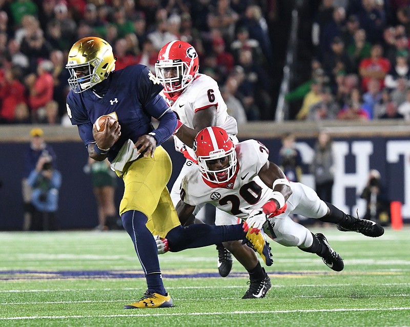 Georgia safety J.R. Reed brings down Notre Dame quarterback Brandon Wimbush as inside linebacker Natrez Patrick gives chase during the Bulldogs' 20-19 win on Sept. 9.