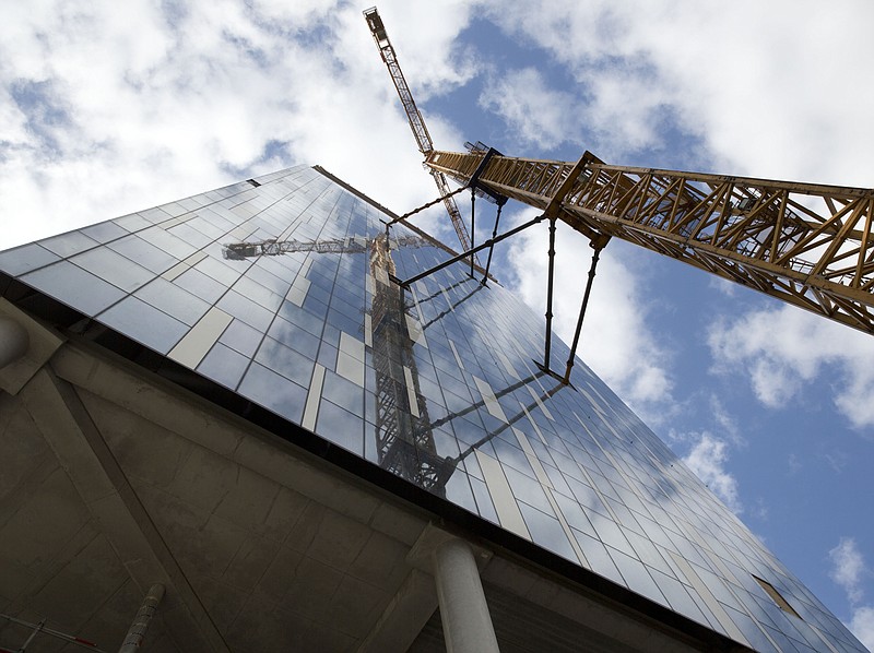 
              A crane looms over the facade of a building which is proposed to host the European Medicines Agency during a presentation of Belgium's bid to host the agency in Brussels, Tuesday, Oct. 3, 2017.  There is heavy competition to relocate the European Medicines Agency and the European Banking Authority from London to be headquartered in an EU country, with many EU nations still confident they can win their bid which will bring money and prestige to the host country.  (AP Photo/Virginia Mayo)
            