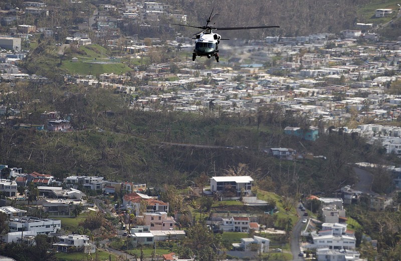 
              Marine One helicopter carrying President Donald Trump surveys areas impacted by Hurricane Maria, Tuesday, Oct. 3, 2017, near San Juan, Puerto Rico. (AP Photo/Evan Vucci)
            