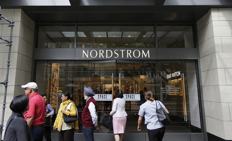 
              In this Wednesday, Sept. 13, 2017, photo, people stand near an entrance for Nordstrom Inc.'s flagship store in downtown Seattle. In information released Tuesday, Oct. 3, 2017, the National Retail Federation is forecasting holiday sales for the November and December period to rise between 3.6 percent and 4 percent to $678.75 billion to $682 billion. (AP Photo/Ted S. Warren)
            