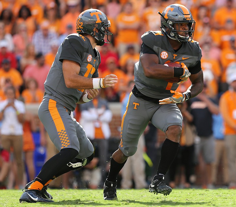 University of Tennessee quarterback Quinten Dormady (12) hands the ball off to running back John Kelly (4) during the University of Tennessee vs. University of Georgia football game at Neyland Stadium in Knoxville, Tenn., Saturday, Sept. 30, 2017.