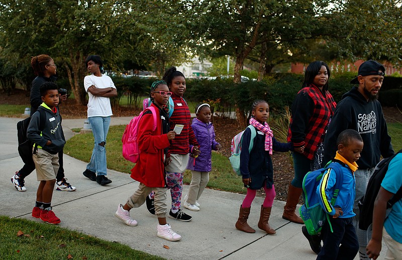 Brown Elementary students walk on the University Greenway from the University of Tennessee at Chattanooga's Challenger Center to school on East Eighth Street for International Walk to School Day on Tuesday, October 3, 2017, in Chattanooga, Tenn. Ten area schools have organized walk to school events this week in partnership with the Chattanooga-Hamilton County and North Georgia Transportation Planning Organizations.