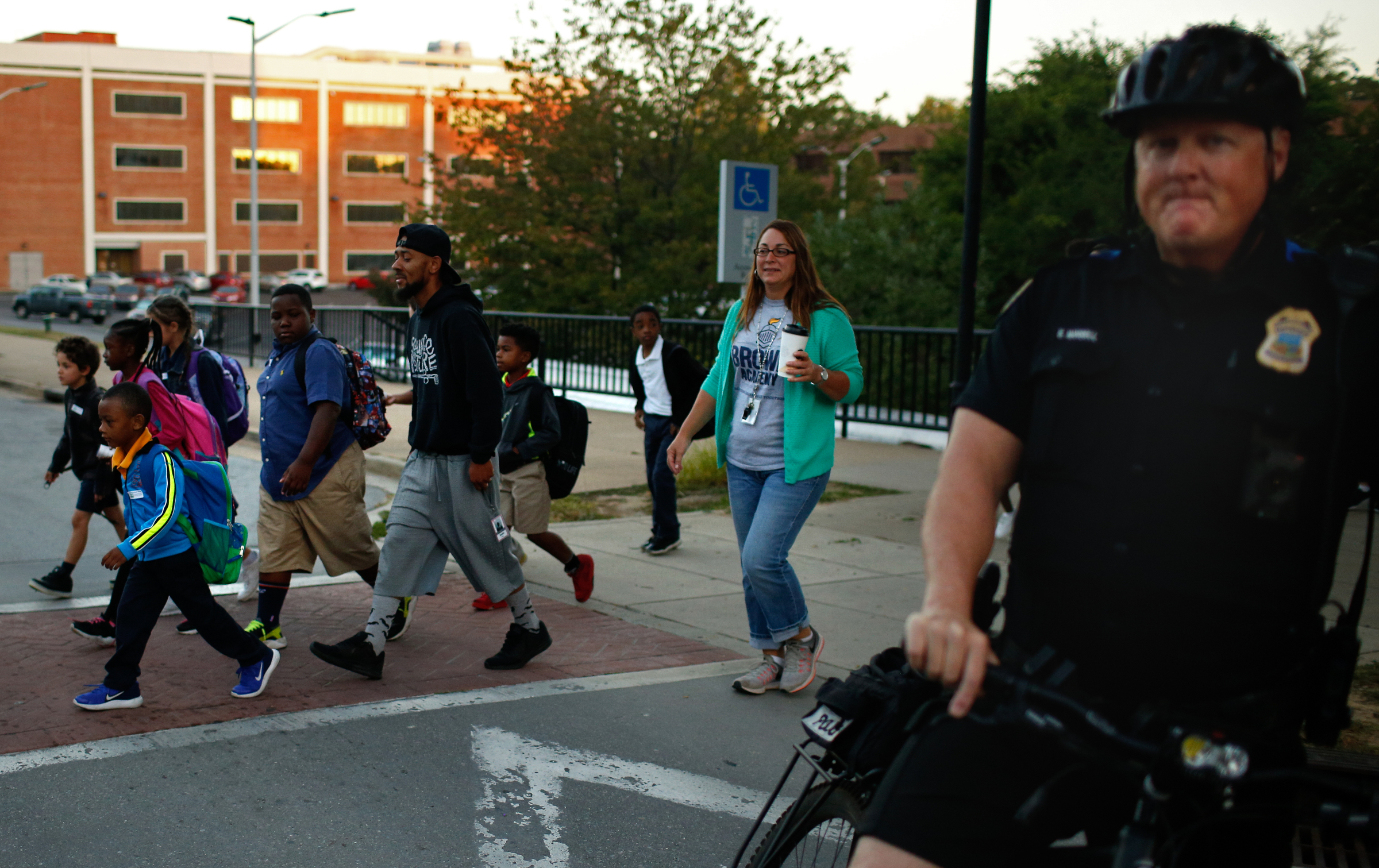 Chattanooga police Officer Eddie Mansell blocks Vine Street as Brown Elementary students walk from the University of Tennessee at Chattanooga's Challenger Center to school on East Eighth Street for International Walk to School Day on Tuesday, October 3, 2017, in Chattanooga, Tenn. Ten area schools have organized walk to school events this week in partnership with the Chattanooga-Hamilton County and North Georgia Transportation Planning Organizations.