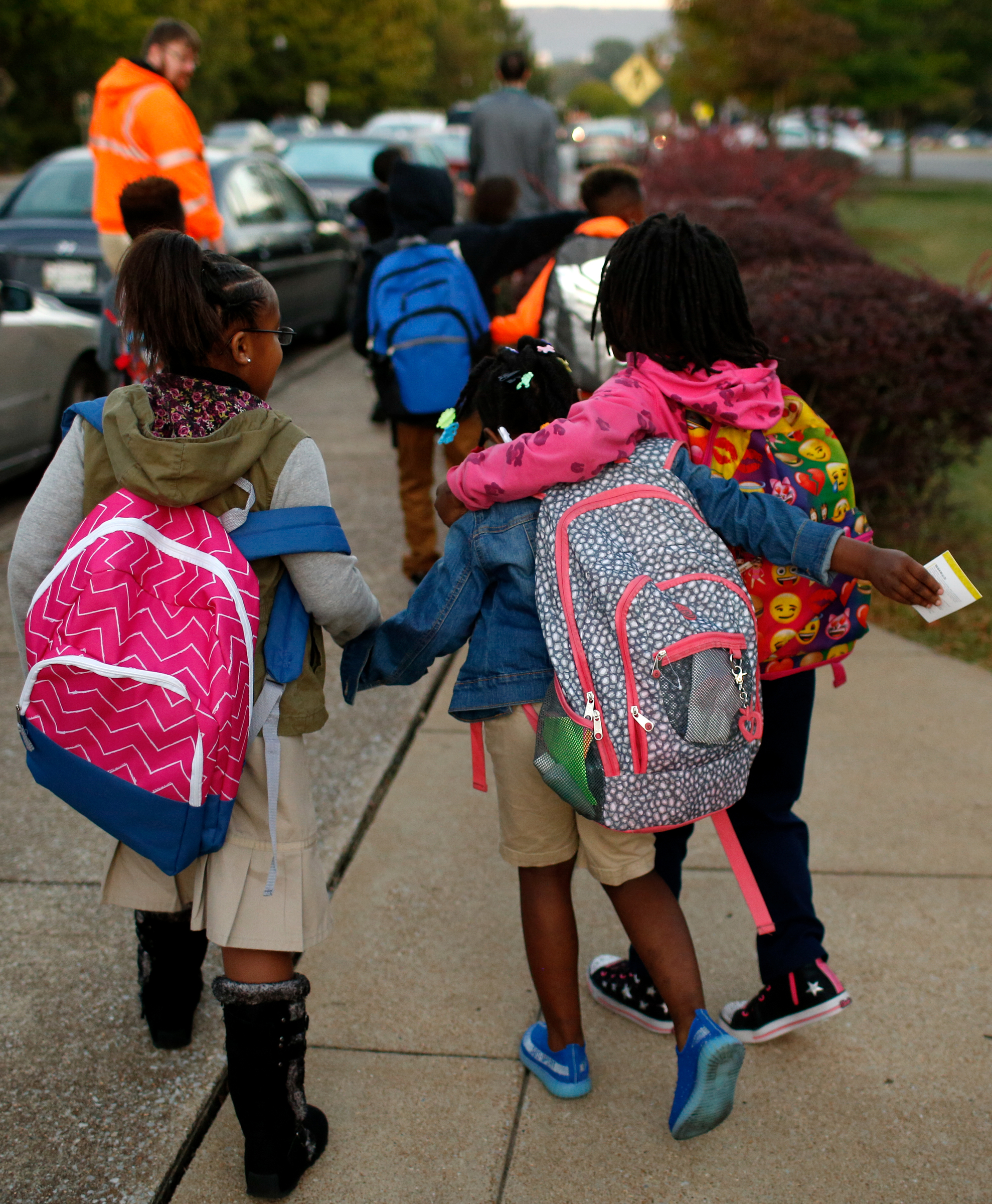 Brown Elementary students embrace as they walk from the University of Tennessee at Chattanooga's Challenger Center to school on East Eighth Street for International Walk to School Day on Tuesday, October 3, 2017, in Chattanooga, Tenn. Ten area schools have organized walk to school events this week in partnership with the Chattanooga-Hamilton County and North Georgia Transportation Planning Organizations.