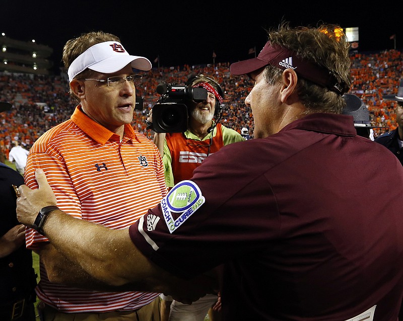 Auburn coach Gus Malzahn, left, and Mississippi State coach Dan Mullen shake hands after Malzahn's Tigers routed Mullen's Bulldogs this past Saturday. Auburn is 2-0 in SEC play this season, with a combined score of 100-24 in the victories against Missouri and Mississippi State.