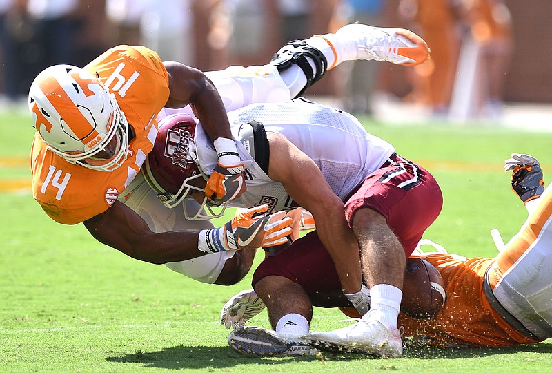 Tennessee linebacker Quart'e Sapp (14) and cornerback Justin Martin tackle UMass quarterback Andy Isabella during their Sept. 23 game at Neyland Stadium.