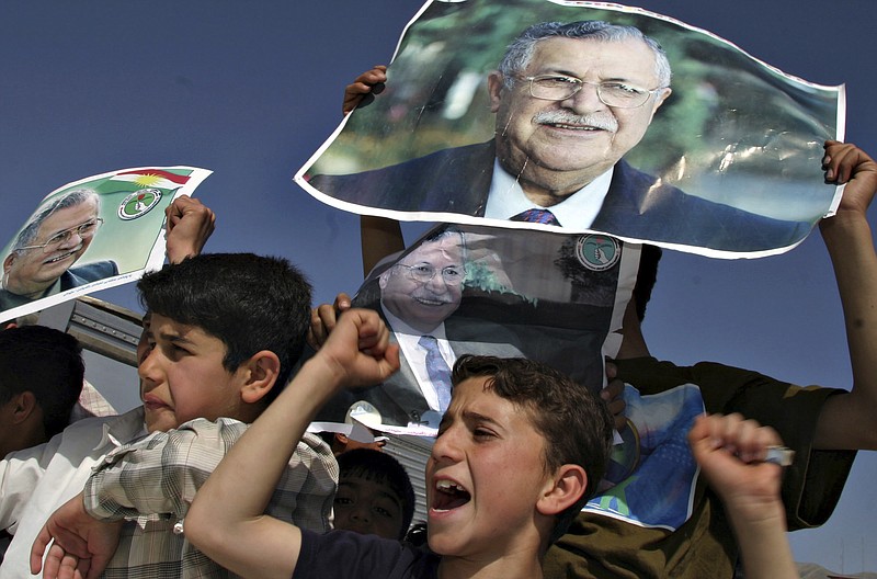 
              FILE - In this April 6, 2005 file photo, Kurdish youngsters celebrate the election of then Iraqi President Jalal Talabani, in downtown Sulaimaniyah, Iraq. Talabani, a lifelong fighter for Iraq’s Kurds who rose to become the country’s president, presenting himself as a unifying father figure to temper the potentially explosive hatreds among Kurds, Shiites and Sunnis has died in a Berlin hospital at the age of 83. (AP Photo/Sasa Kralj, File)
            