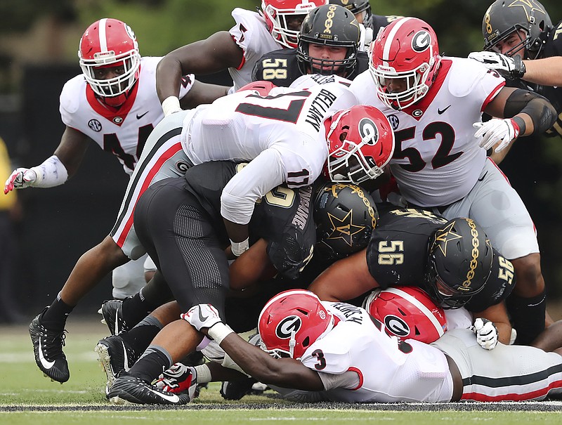 Georgia defenders Davin Bellamy (17), Tyler Clark (52) and Roquan Smith (3) stuff Vanderbilt running back Khari Blasingame during Saturday's 45-14 win by the Bulldogs. The Commodores were held to 236 total yards, but Georgia defenders were not happy with their showing in Nashville.