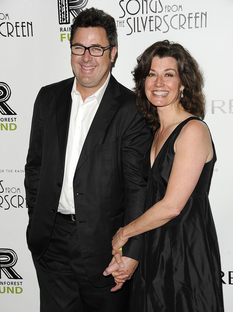 
              FILE - In this April 3, 2012, file photo, musician Vince Gill and wife, singer Amy Grant, attend the Revlon Concert for the Rainforest Fund dinner and auction at The Pierre Hotel in New York. Many artists have used their voices to pray, to cry and to offer peace and comfort in the wake of the Oct. 1, 2017 mass shooting at a country music festival. Alongside her husband Gill, Grant lead a prayer at a vigil in Nashville on Monday, Oct. 2, a day after the shooting in Las Vegas. (AP Photo/Evan Agostini, File)
            