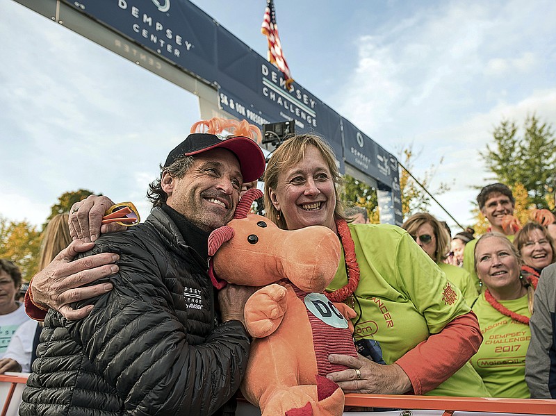 
              Actor Patrick Dempsey poses with Nina Houghton at the starting line of the Dempsey Challenge, a cancer fundraiser, on Saturday, Oct. 7, 2017 in Lewiston, Maine.  Dempsey created the bike-and-run Dempsey Challenge to raise money for a cancer center created in 2008 in partnership with the Central Maine Medical Center in Lewiston.  He was inspired by his mother, Amanda, who died of cancer in 2014.  (Andree Kehn/The Lewiston Sun-Journal via AP)
            