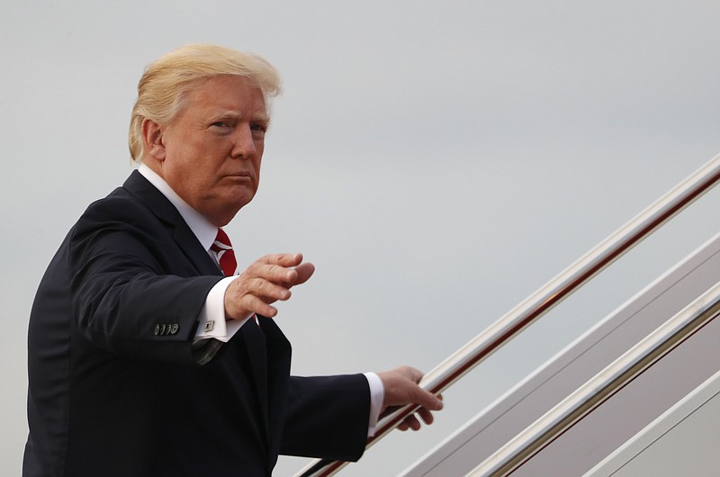 President Donald Trump waves as he boards Air Force One, Saturday, Oct. 7, 2017, in Andrews Air Force Base, Md., en route to a fundraiser in Greensboro, N.C. (AP Photo/Carolyn Kaster)