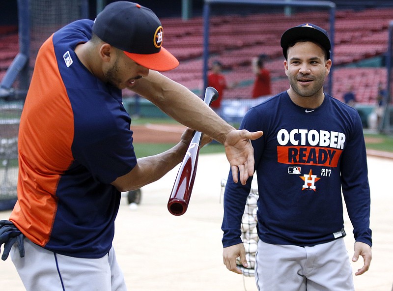 
              Houston Astros' Carlos Correa, left, talks with Jose Altuve, right, during a workout, Saturday, Oct. 7, 2017, as the team prepares for Sunday's Game 3 of baseball's American League Division Series against the Boston Red Sox in Boston. (AP Photo/Bill Sikes)
            