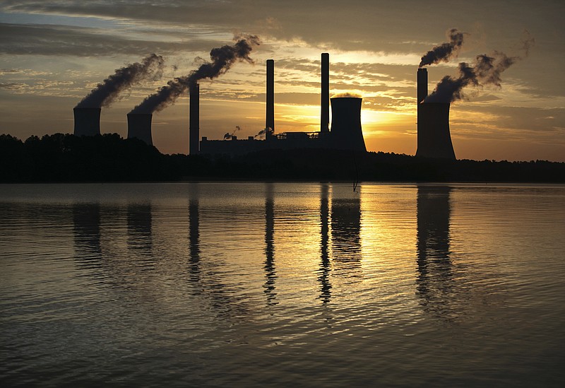 
              FILE - In this June 3, 2017 file photo, the coal-fired Plant Scherer, one of the nation's top carbon dioxide emitters, stands in the distance in Juliette, Ga. Technology now in limited use removes about 90 percent of carbon dioxide from the smokestacks of coal-fired power plants, but energy experts say cost remains the chief obstacle to bringing the “clean coal” touted by President Donald Trump into the mainstream. (AP Photo/Branden Camp, File)
            